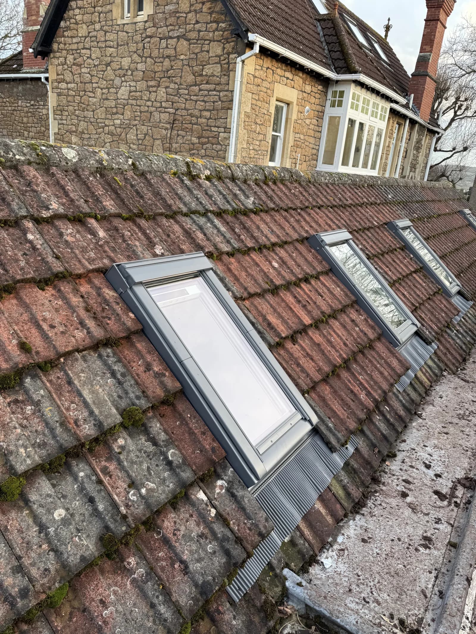 Two VELUX roof windows side by side on a tiled roof