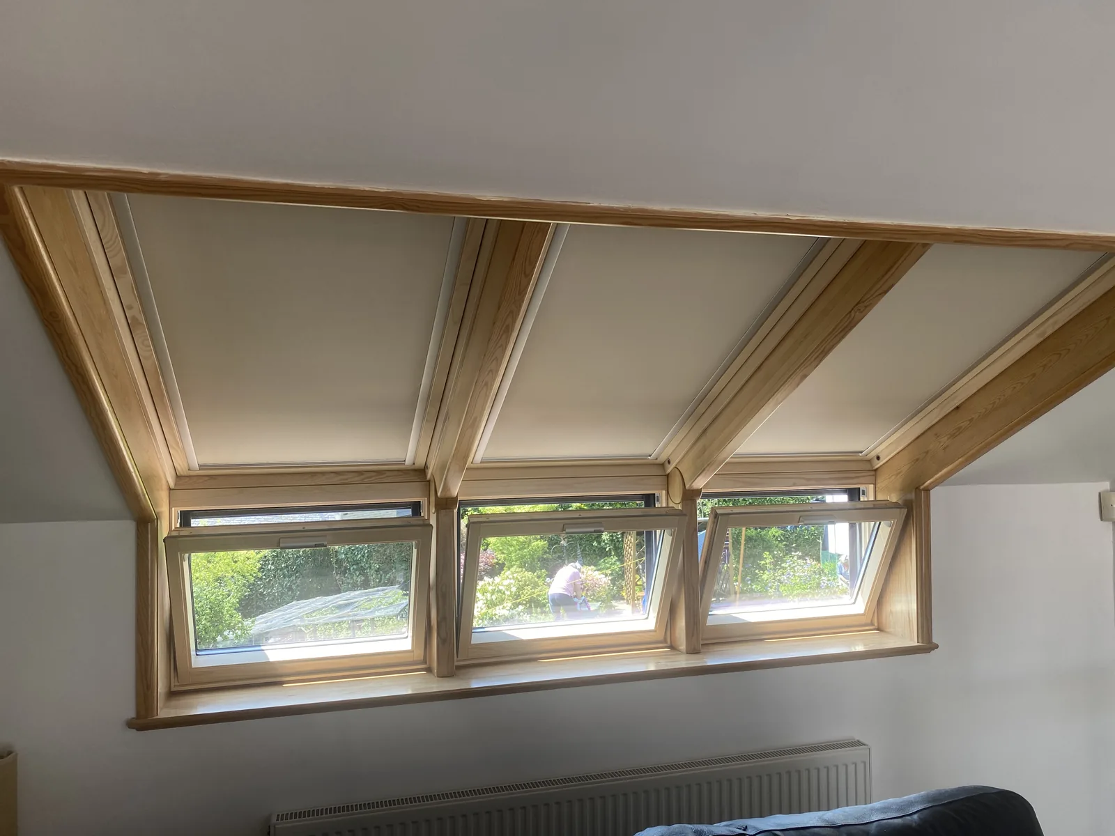 A bank of four roof windows in a timber-framed interior