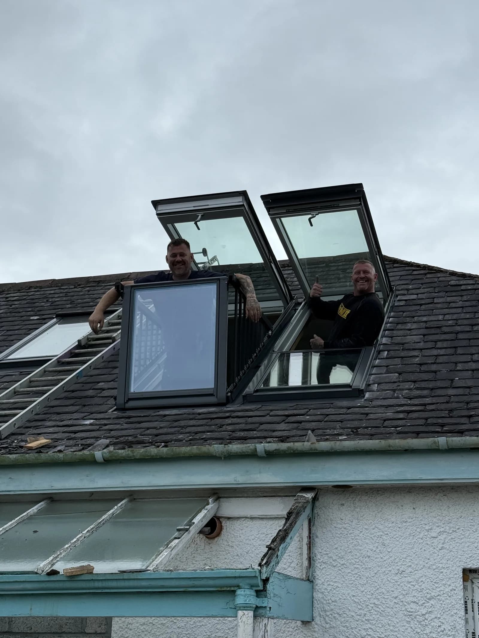 Installer working beside open roof windows