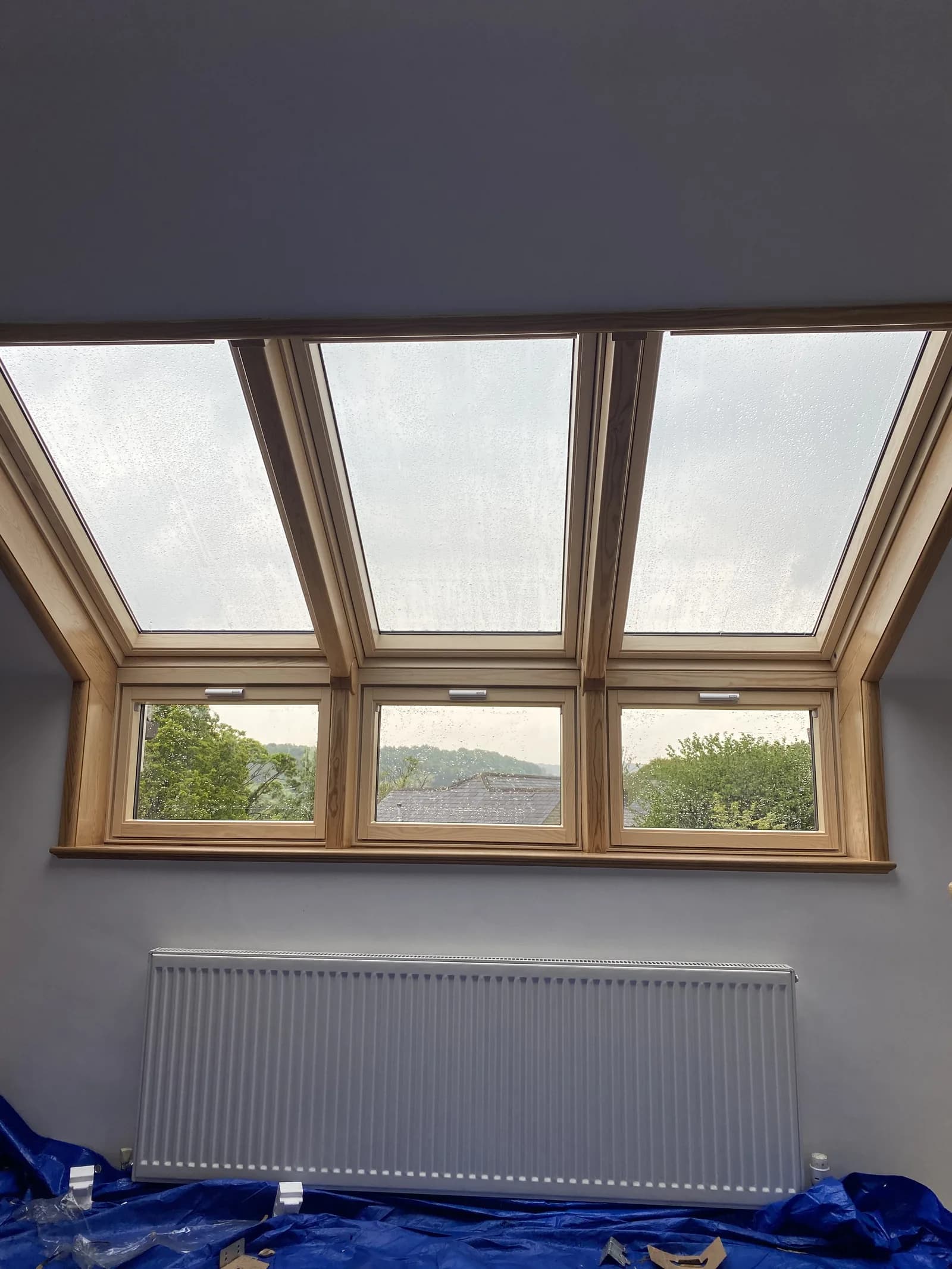 Roof window with a timber frame and countryside view