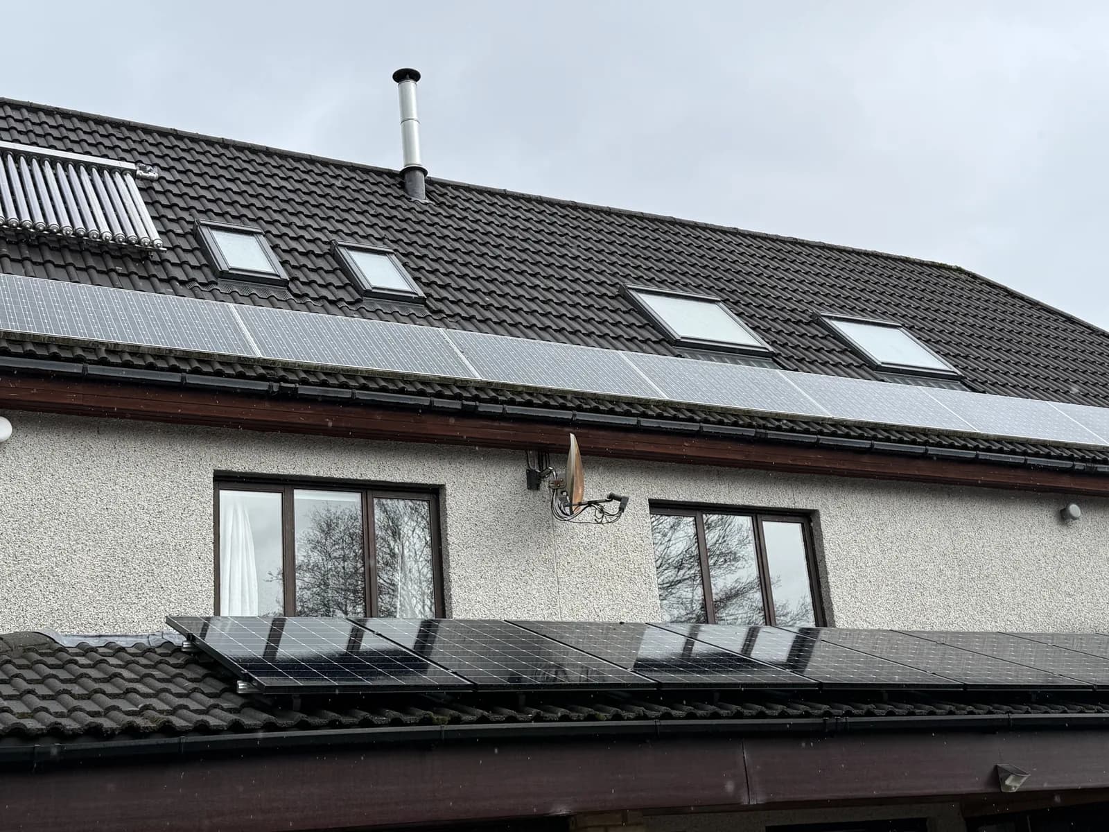 Several roof windows on a rendered house exterior