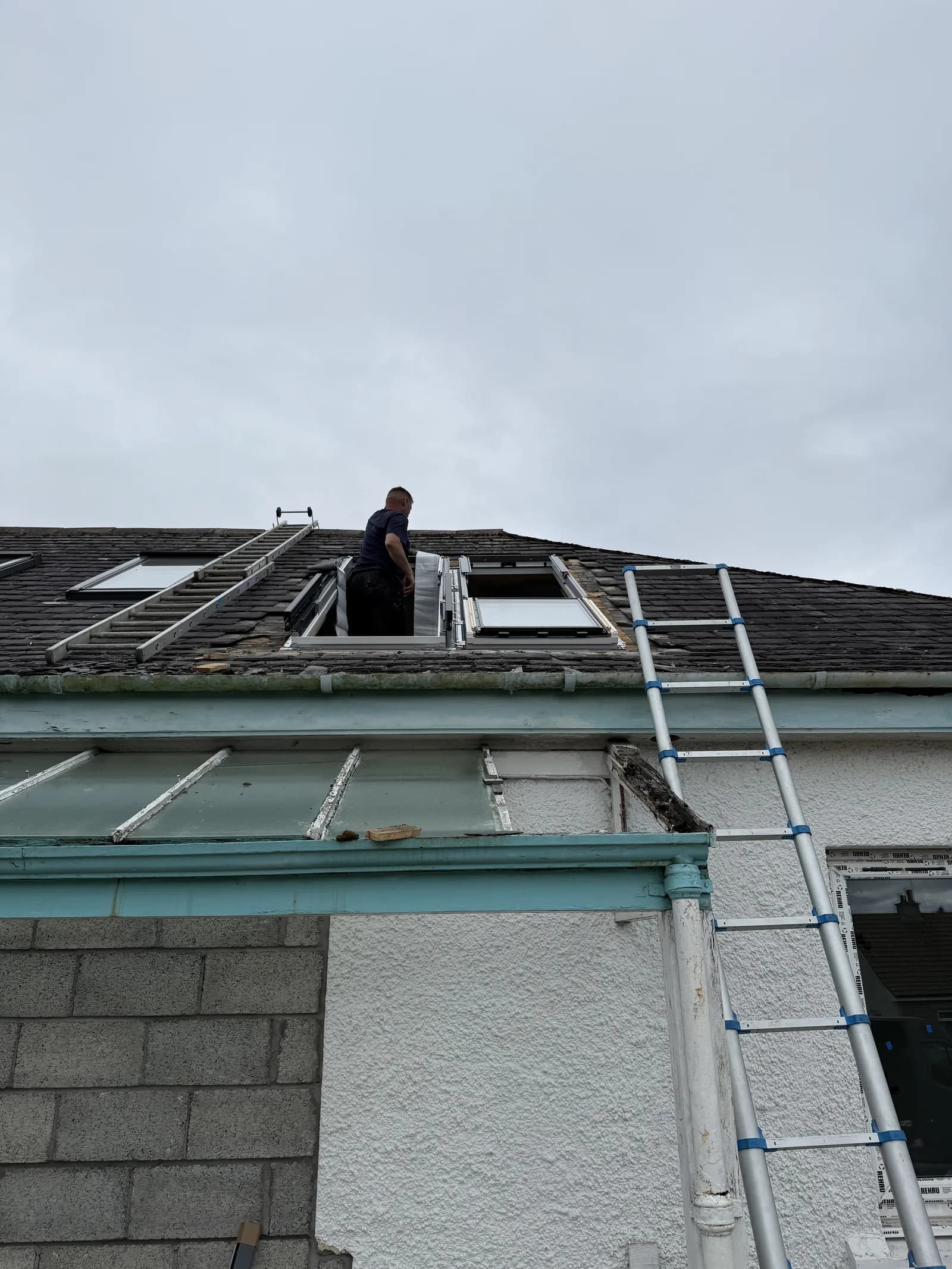 Tru Skylights installer working on scaffolding at roof level