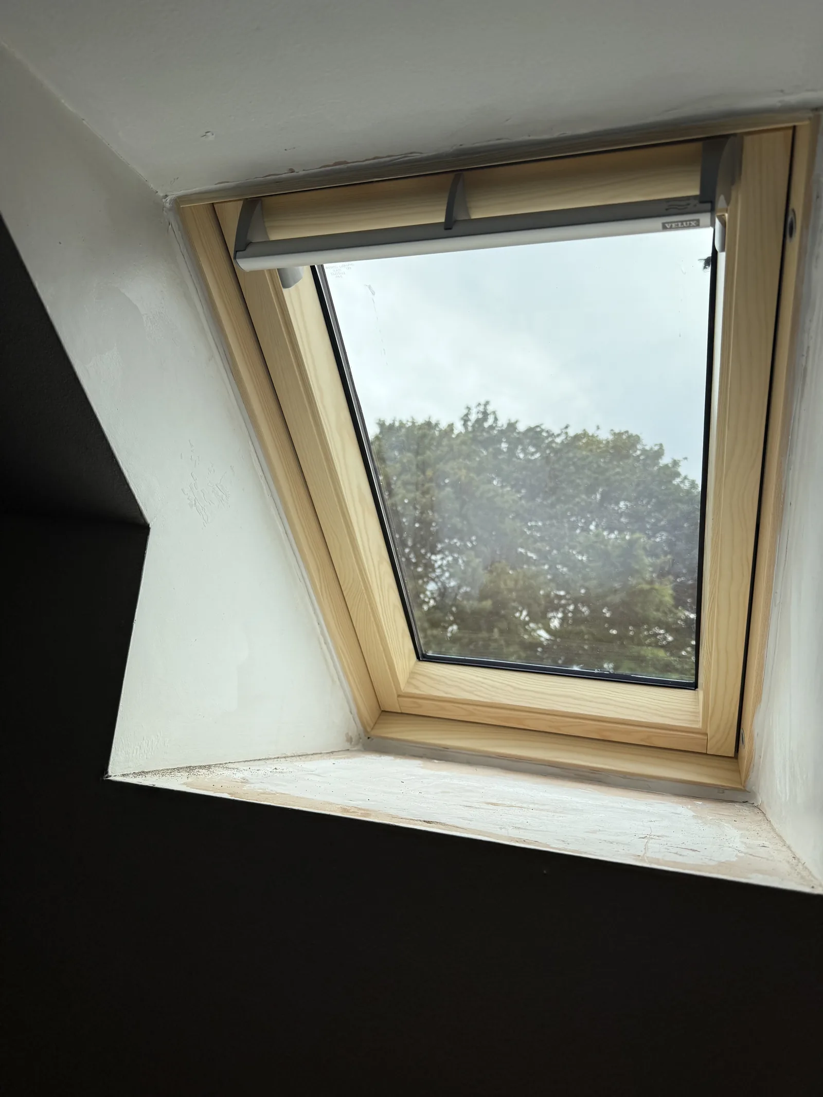 Interior view of a roof window with a fitted blind